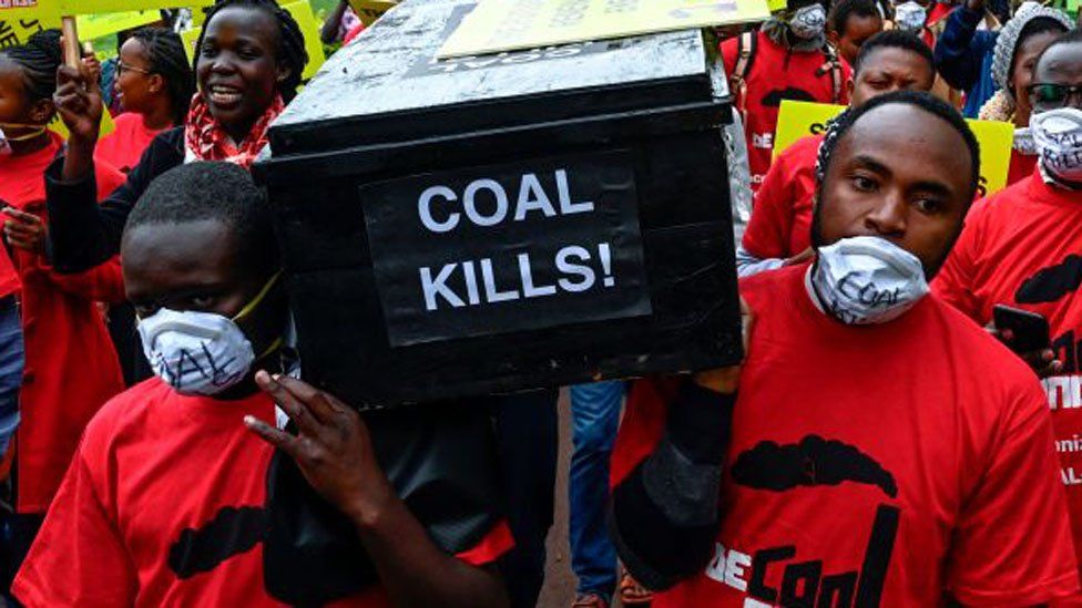Protesters carrying a coffin which says 'coal kills'.
