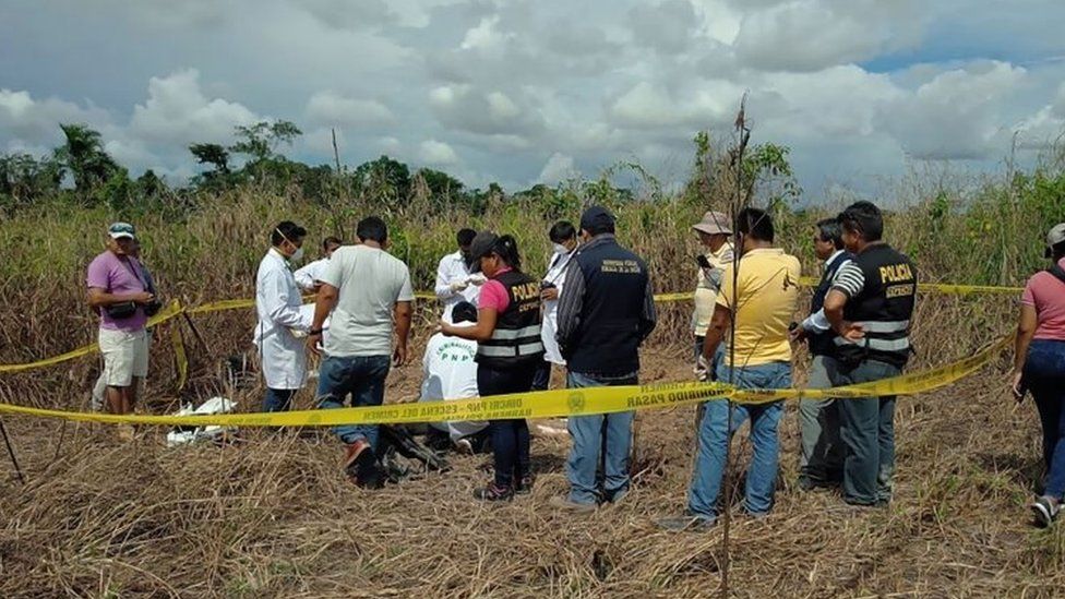 Policemen and locals unearth the body of a Canadian man in Peru on April 21, 2018.