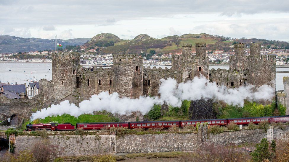 Galatea passing along the north Wales coast and steaming past Conwy Castle