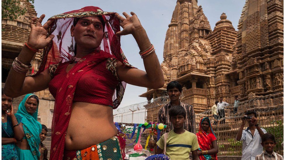 A group of hijras dancing in front of Khajuraho temples in Madhya Pradesh, India.