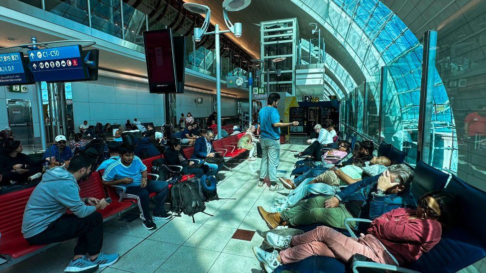 Passengers wait for their flights at the Dubai International Airport in Dubai