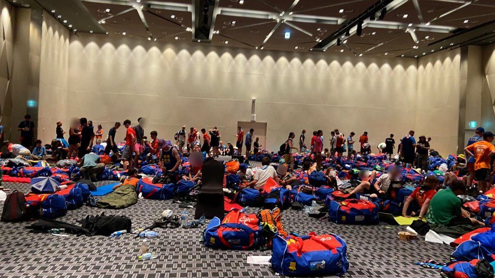 A group of scouts and their equipment in a large hotel room