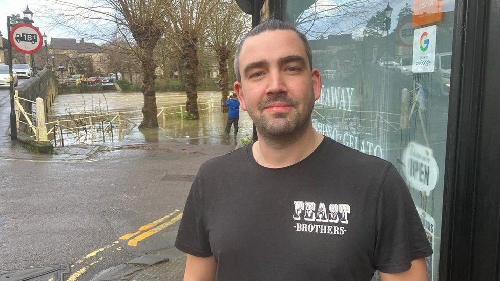Scott Wheeler, with flooding in the background in Bradford-on-Avon