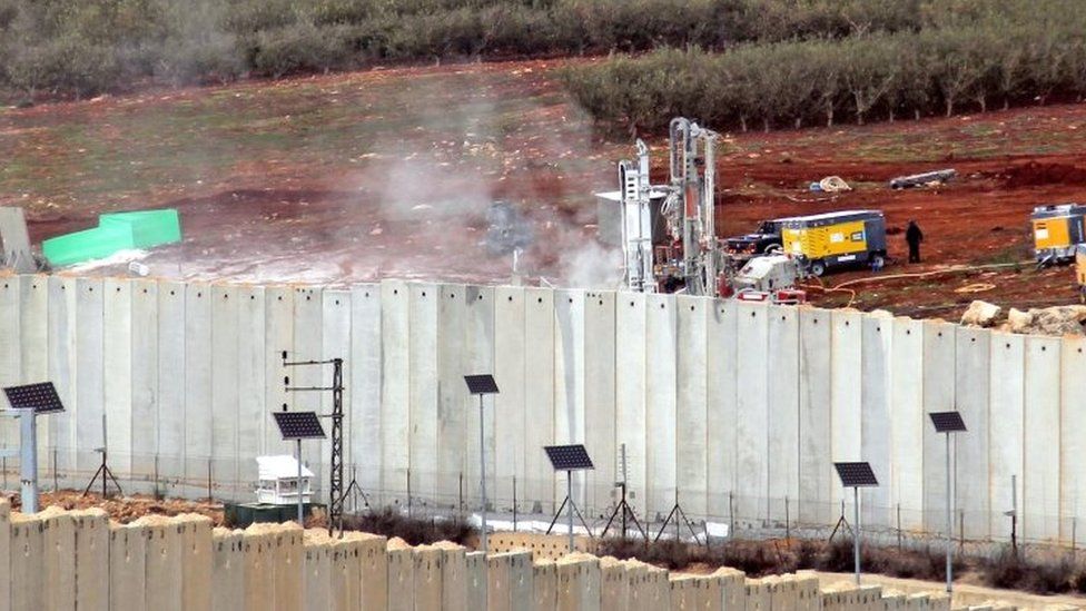 A view of Israeli machinery operating behind the border wall in Israel on 4 December