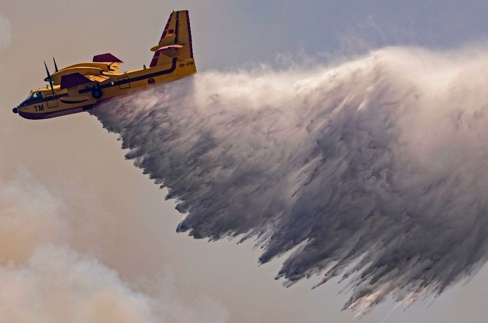 A Royal Moroccan Air Force Canadair plane douses a wildfire in the region of Chefchaouen of northern Morocco on August 17, 2021