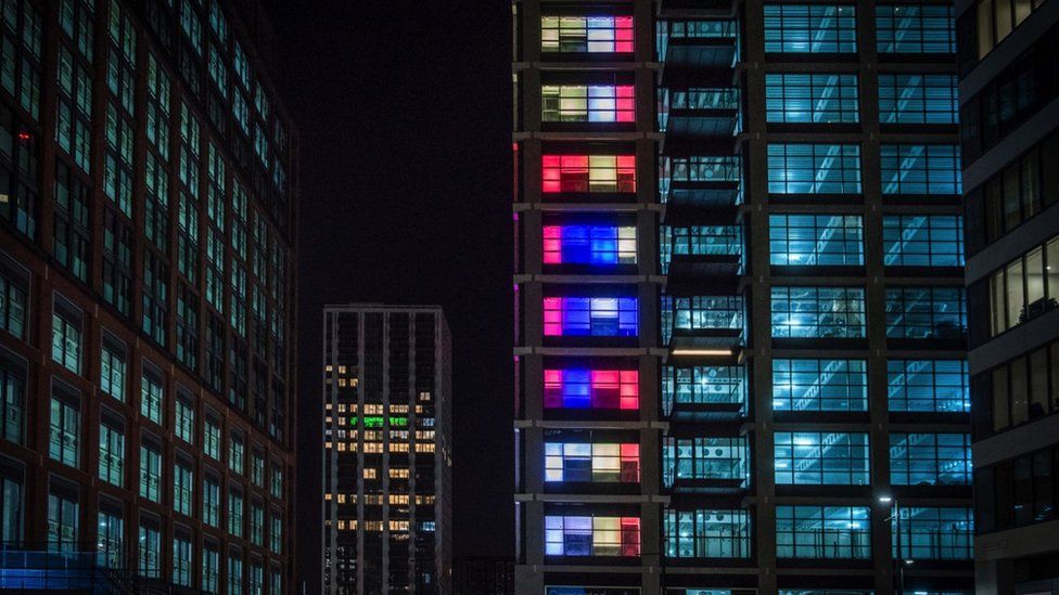 Office blocks are lit up in various colours