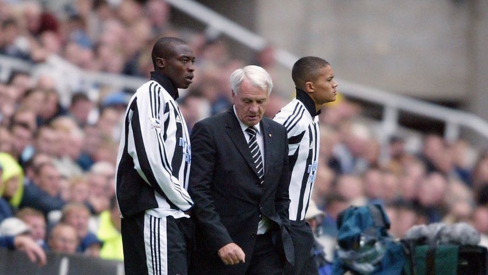 Newcastle Manager Bobby Robson is flanked by substitutes Shola Ameobi (left) and Jermaine Jenas during the FA Barclaycard Premiership match between Newcastle United and Bolton Wanderers at St. James Park September 20, 2003 in Newcastle,