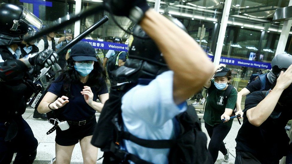 Police clash with anti-government protesters at the airport in Hong Kong, August 13, 2019
