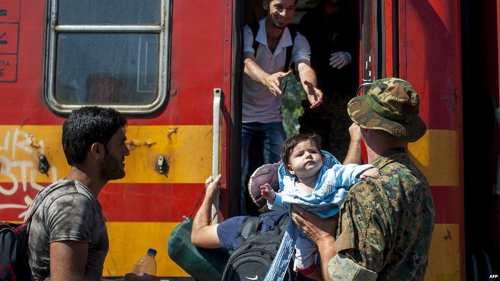 Migrants board train at Gevgelija, Macedonia, 23 August 2015