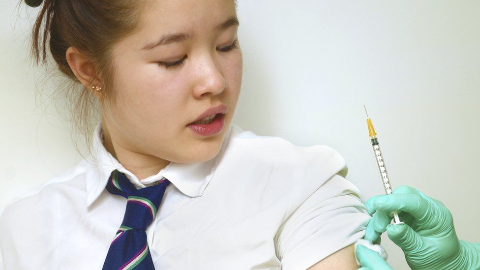 Schoolgirl getting vaccinated