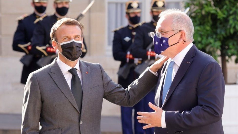 Emmanuel Macron pats Scott Morrison on the shoulder during a meeting in Paris in June