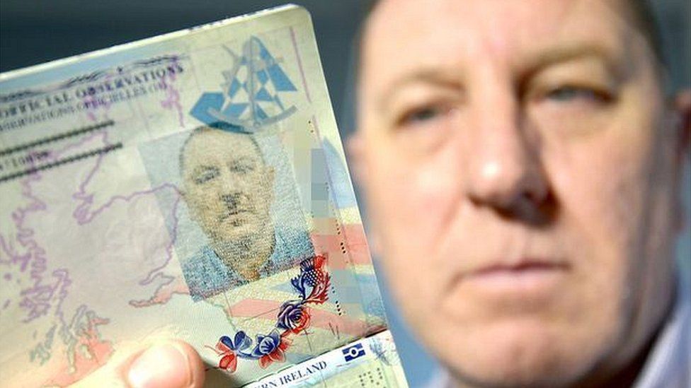 Stuart Boyd holding up passport photo page