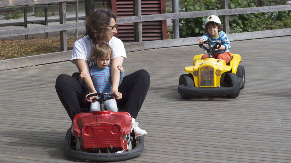 Alejandra Fuentes and her children driving go-karts