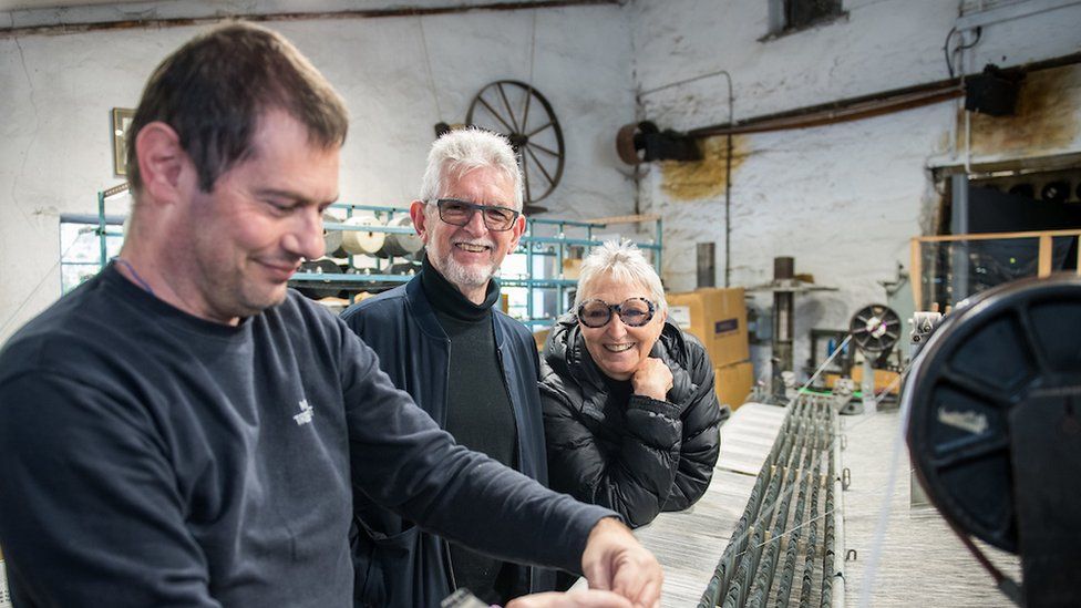 staff member alongside Eifion and Amanda Griffiths