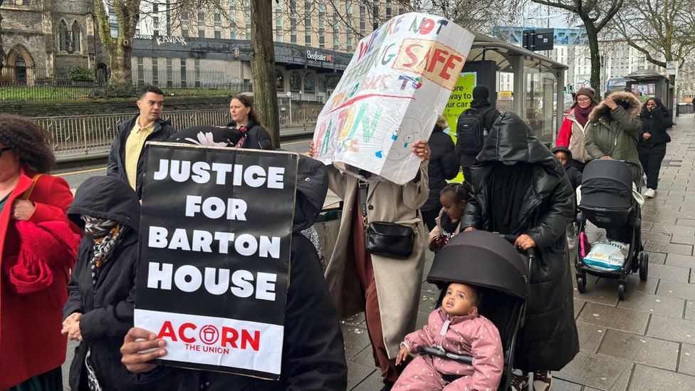 Residents marching with signs including one saying 'Justice for Barton House'