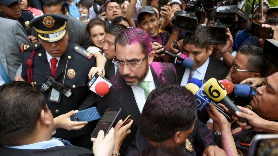 Mexico's security minister Jesus Orta was sprayed with pink glitter during the protests