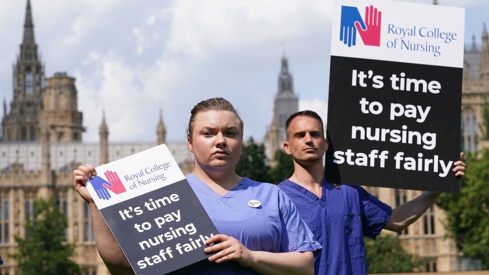 Royal College of Nursing members with placards outside Parliament in July