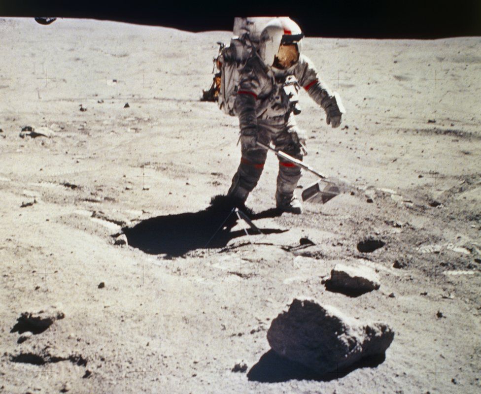 astronaut on the Moon collecting rocks