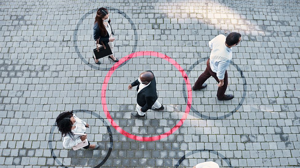 Passing pedestrians with circles drawn around each of them to signify transmission of Covid