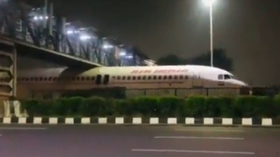 The Air India plane stuck under the bridge
