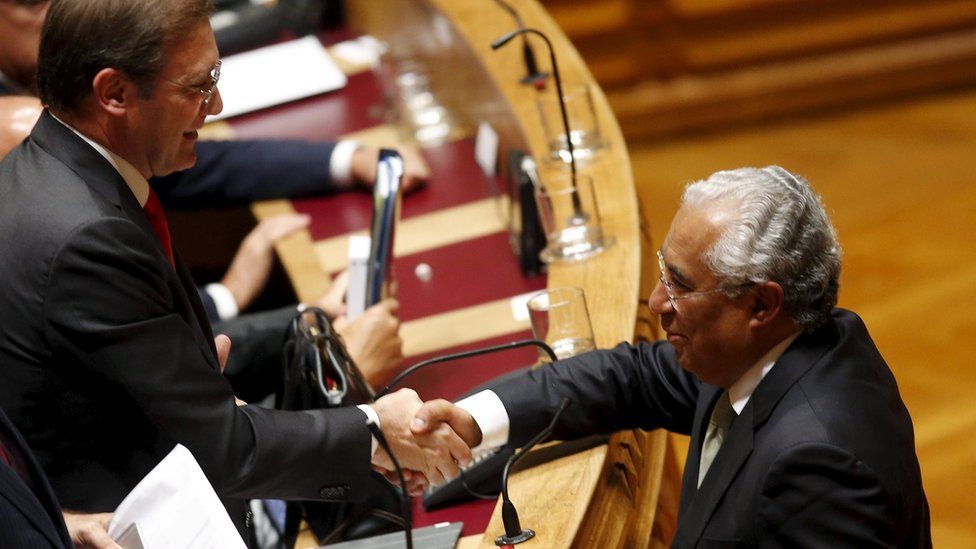 Portuguese PM Pedro Passos Coelho shakes hands with Socialist leader Antonio Costa