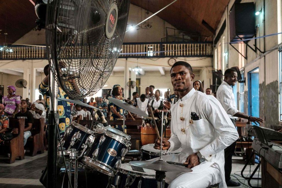 A drummer dressed in a white suit performs during service at St Mary's Catholic church in Port Harcourt, Nigeria - Sunday 17 February 2019