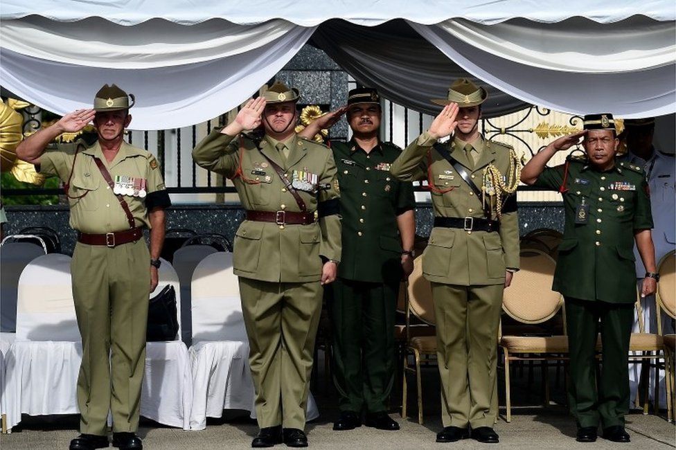 Malaysian and Australian military officials salute at the Subang airforce base in Malaysia (31 May 2016)