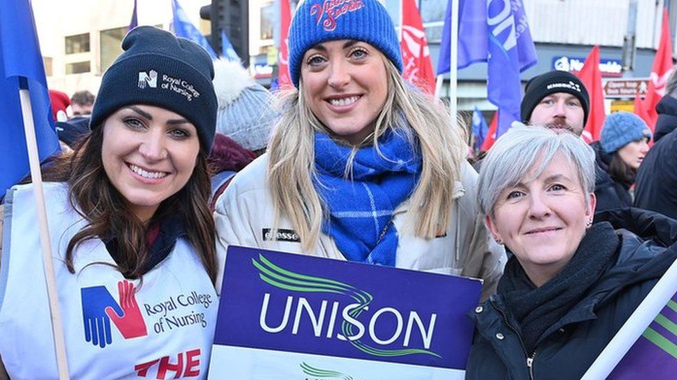 Female workers on strike, at Belfast rally