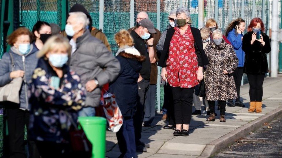 People queue at a coronavirus disease (COVID-19) testing centre in Liverpool on Friday