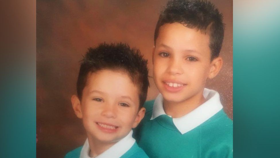 Tyler Edwards and his younger brother having their photo taken in primary school