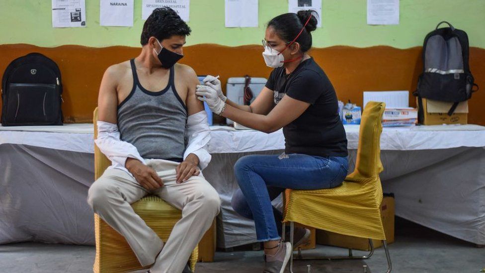 A health worker administers a dose of Covid vaccine to a beneficiary, at a Vaccination centre in Inderpuri, on June 4, 2021 in New Delhi, India.