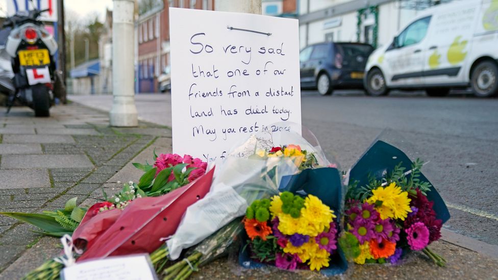 Flowers have been left at the entrance to Bibby Stockholm