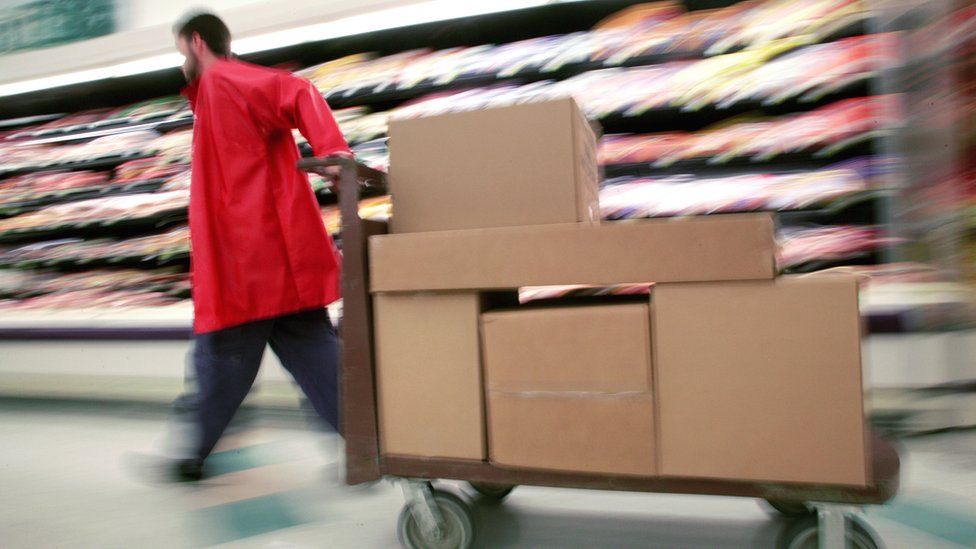 Man pulling cart with boxes