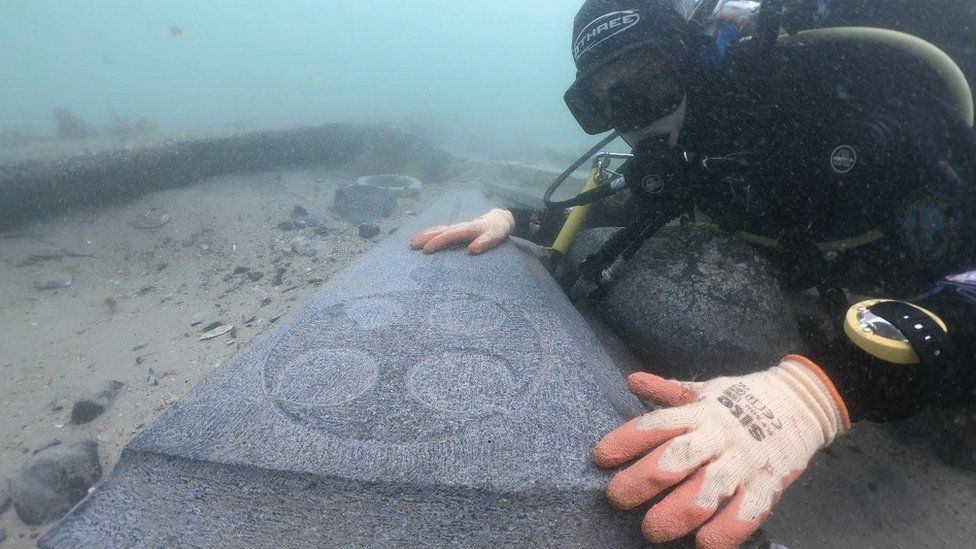 A diver looking at one of the Purbeck stone gravestones