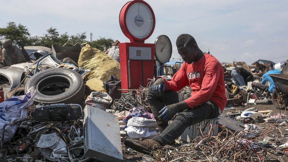 A man sorts through electronic waste at the Agbogbloshi electronic waste site in Accra, Ghana - Monday 27 August 2018