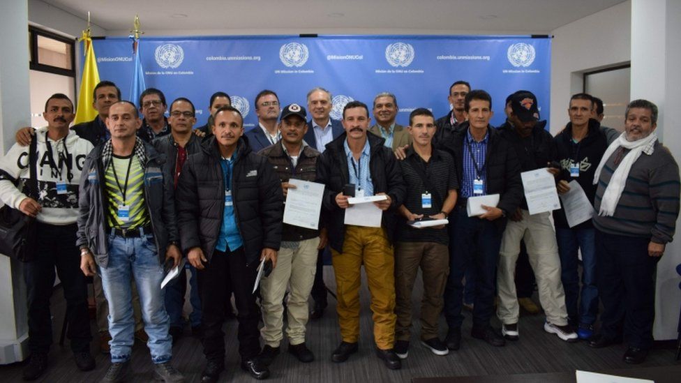 UN Secretary General's Special Representative for Colombia and Head of the UN Mission to Colombia, Jean Arnault (C), Revolutionary Armed Forces of Colombia (FARC) member Marco Calarca (R) and other members of the FARC