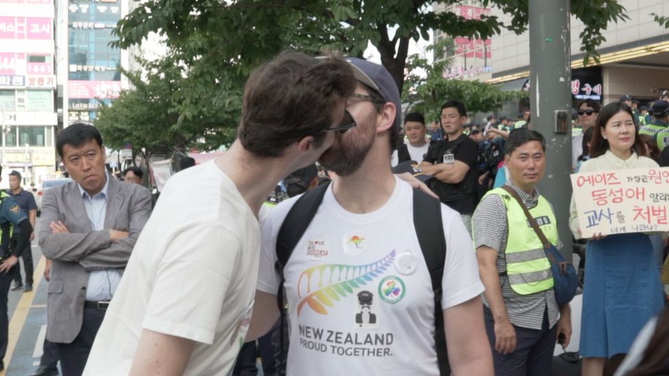 Two Western men kiss at the Incheon Queer festival