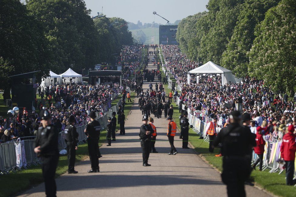 Police offers and spectators gather on the Long Walk ahead of the wedding of Prince Harry and Meghan Markle.