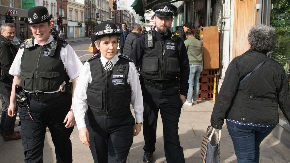 Metropolitan Police Commissioner Cressida Dick (centre) walks with officers through Stoke Newington in north London