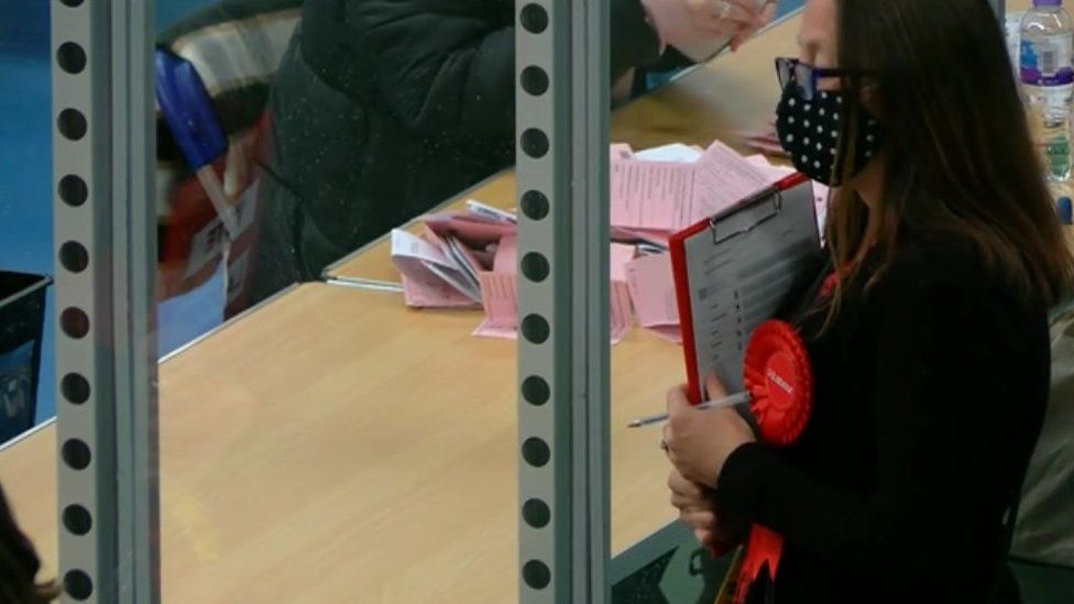 A woman with a Labour rosette at a count