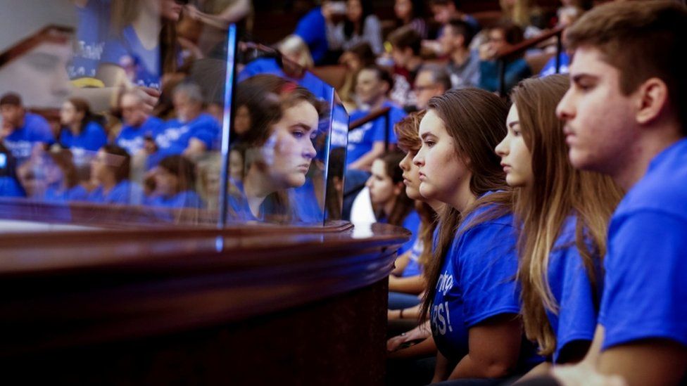 Students sit in gallery of Florida Senate, all in blue t-shirts in tribute to the shooting