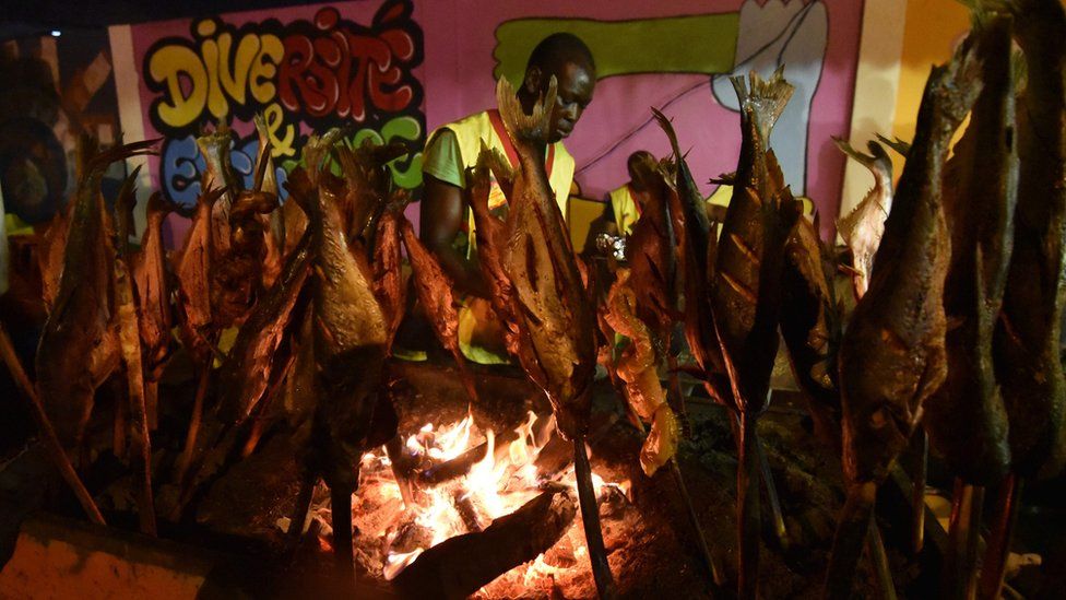 Fish is prepared during the annual Grill Festival on September 10, 2017 in Abidjan, a gastronomic fair bringing together thousands from various ethnic groups to the Ivorian capital