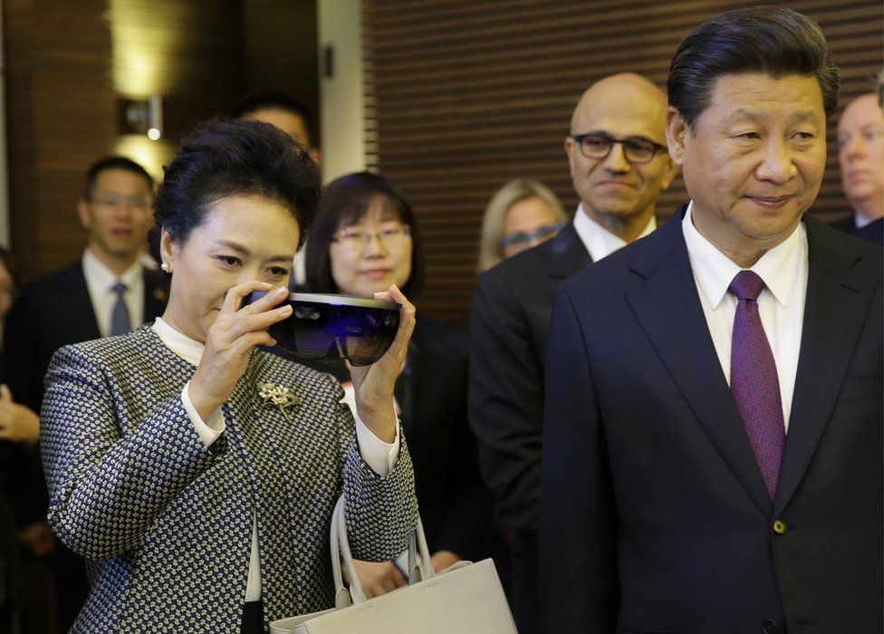 Peng Liyuan, left, stands next to her husband, Chinese President Xi Jinping as she examines Micosoft's HoloLens device during a tour of Microsoft's main campus in Redmond, Wash., Wednesday, 23 September 2015