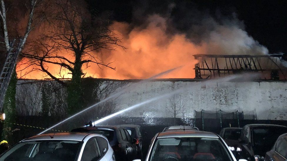 Pictures showed multiple hoses being used as large flames and smoke rose from the scene, while the roof structure of the building appeared to be badly damaged.