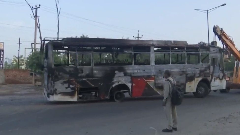 A burnt bus being towed away