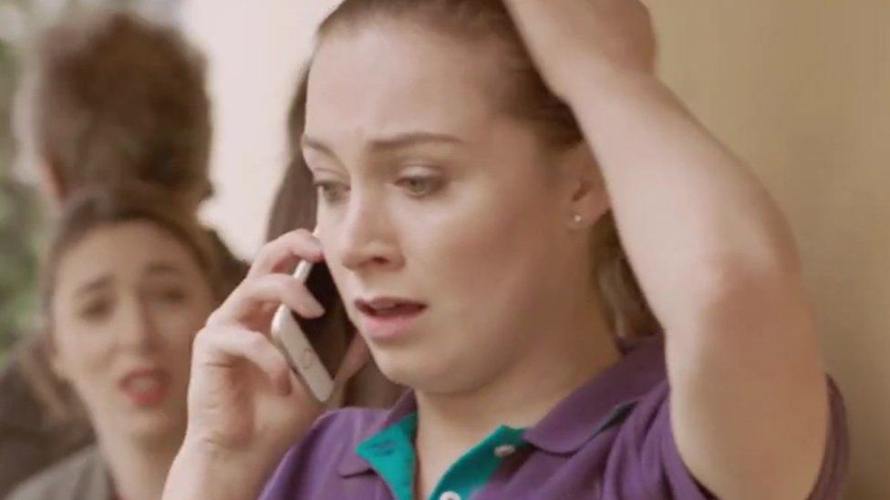 Still from the video of a woman on the phone