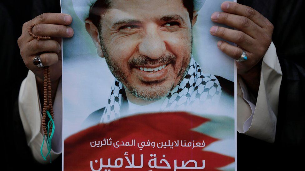 Bahraini anti-government protester holds up an image of jailed Shiite opposition leader Sheikh Ali Salman demanding his freedom during a protest in Daih, Bahrain, on 25 February 2015