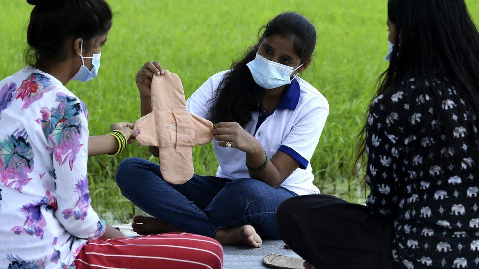 Muni Gupta teaching girls to make homemade reusable sanitary pads