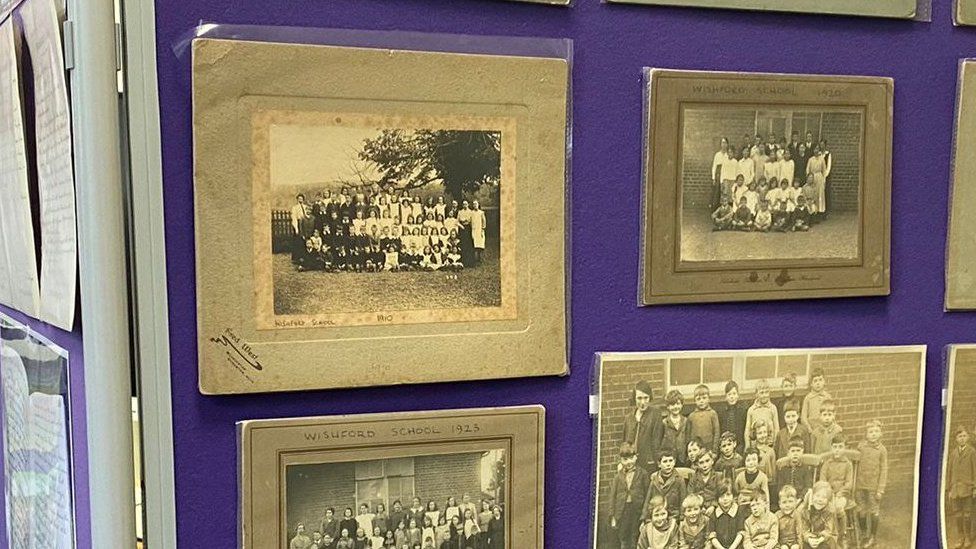 A teacher points to a historical display at Great Wishford Primary School