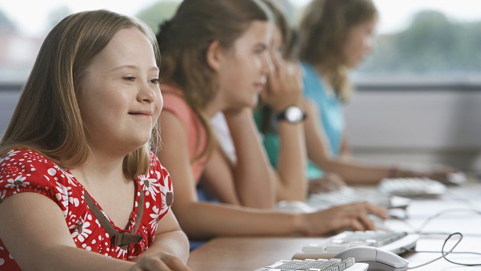 A girl with Down's Syndrome sitting with other children in school (file image)